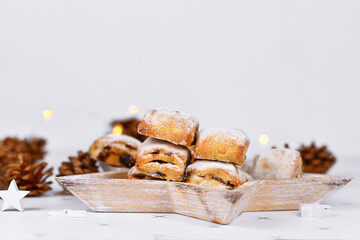 German Stollen cake pieces, a fruit bread with nuts, spices, and dried fruits with powdered sugar...
