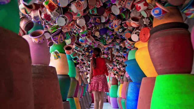 Travel people explore traditional market Ubud with scenery ceramics flower pot in a picturesque pottery shop Bali, Indonesia 4K