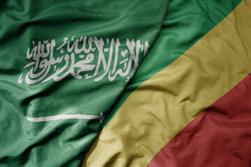 big waving realistic national colorful flag of saudi arabia and national flag of republic of the congo .