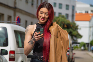 Fototapeta premium urban young woman with phone walking on the street