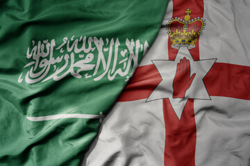 big waving realistic national colorful flag of saudi arabia and national flag of northern ireland .