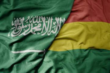 big waving realistic national colorful flag of saudi arabia and national flag of bolivia .