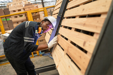 Fototapeta na wymiar African American technician craft man checking timber at wood factory 