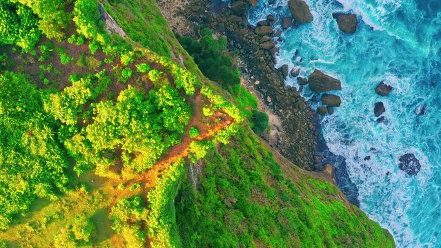 Travel people enjoy breathtaking view at Karang Boma Cliff Bali on background ocean waves crashing on the tropical beach Bali Indonesia 4K Aerial view