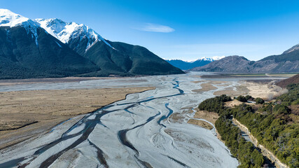 Aerial photography of the braided river with very little water flowing through the alpine Arthurs Pass