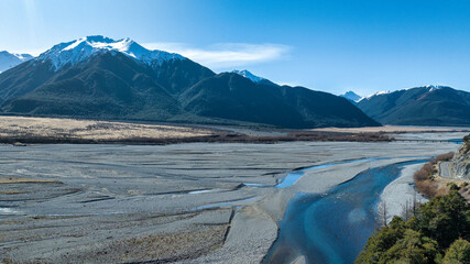 Aerial photography of the braided river with very little water flowing through the alpine Arthurs Pass