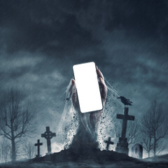 Zombie holding a smartphone in the graveyard