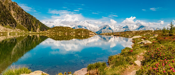 Fototapeta na wymiar High resolution stitched alpine summer panorama with reflections at Lake Klaussee, Mount Klausberg, Ahrntal valley, Pustertal, Trentino, Bozen, South Tyrol