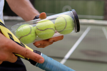 close-up. male hands holding tennis racket and balls