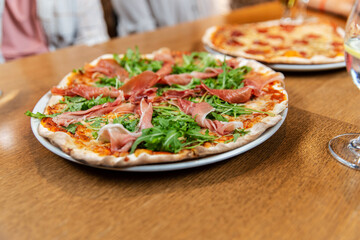 fast food, italian kitchen and eating concept - close up of pizza on wooden table