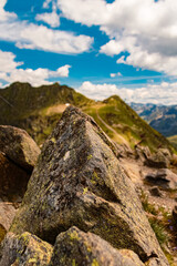 Fototapeta na wymiar Alpine summer view with details of a rock at Mount Kreuzjoch, Schruns, Bludenz, Montafon, Vorarlberg, Austria