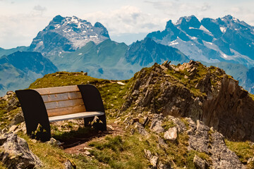 Alpine summer view with details of a wooden bench at Mount Kreuzjoch, Schruns, Bludenz, Montafon,...