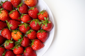 Fresh strawberries just picked from the tree on a white background