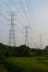 A picture of electric transmission tower during sunrise.