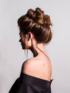 portrait of a woman with backcombed hair styling on the white background