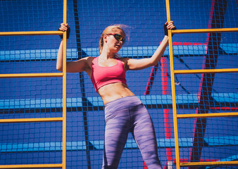 Athletic young woman working out and climbing at the training camp.