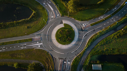 Aerial drone shot of empty roundabout off the A12 in the Netherlands. Dutch road system allows traffic to flow - obrazy, fototapety, plakaty