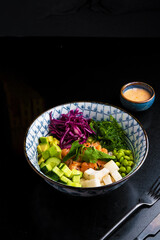 Traditional asian salad in bowl jn black background