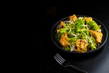 traditional azian food on plate on black background