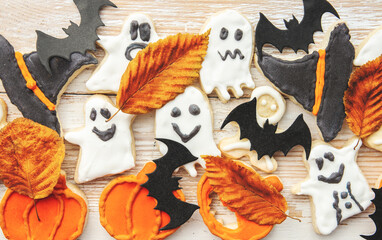 Fototapeta na wymiar Halloween cookies - pumpkin Jack o Lantern, ghost and witch hat sweets. holidays background