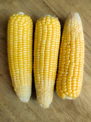 Golden corn kernels are highlighted, showcasing their vibrant yellow hue and plump texture. A symbol of summer and farm-fresh produce, perfect for conveying agricultural abundance and healthy eating.