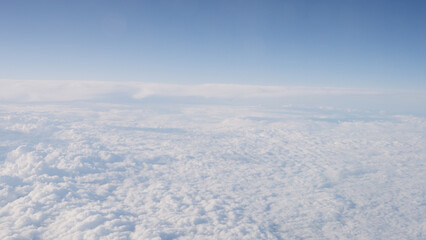 Fototapeta na wymiar Airplane shot, flying over white clouds over europe
