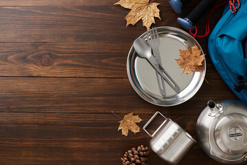 Crafting the perfect autumn outdoor excursion. Top view flat lay of metal utensils, rucksack,...