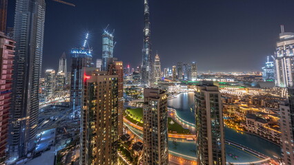 Panorama of Dubai Downtown cityscape with tallest skyscrapers around aerial day to night.