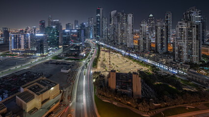 Fototapeta na wymiar Panorama showing Bay Avenue with modern towers residential development in Business Bay aerial night, Dubai