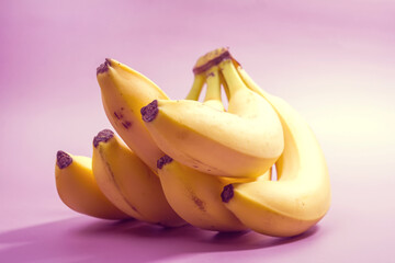 bunch of bananas on purple background