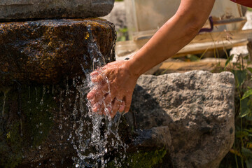 Washing hands in the plateau with water from the mountain