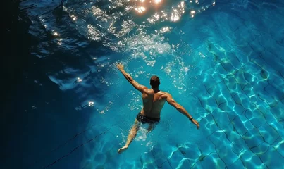  Top view of man swimming in pool. Background for sport and recreation on holiday. © Mangsaab