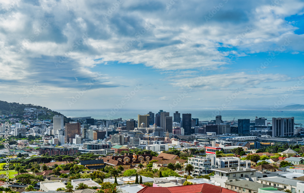 Wall mural Cape Town city centre buildings and atlantic ocean with white clouds and blue sky, Cape Town, South Africa