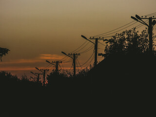 Silhouette of power lines at sunset