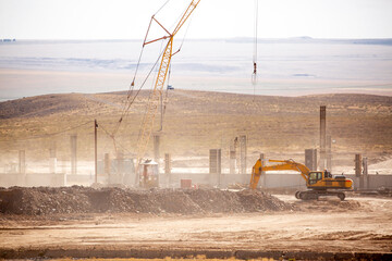 Lifting cranes and other equipment at a construction site. A group of lifting platforms for...