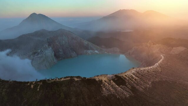 beautiful morning at Ijen volcano in East Jawa, Indonesia, aerial view of volcanic caldera with sulphur gases at dawn, tourism in Ijen volcano national park in Jawa