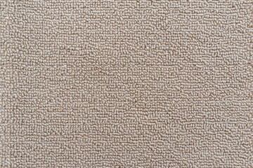 Carpet floor mat or beach towel texture background in sepia beige color made of wool or synthetic fibers, polypropylene, nylon or polyester material - obrazy, fototapety, plakaty