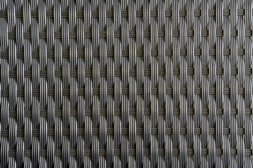 Artificial rattan background in black dark grey color, basket woven texture pattern backdrop for outdoor furniture product manufacturing and interior design decoration - obrazy, fototapety, plakaty