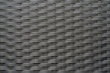 Artificial rattan background in black dark grey color, basket woven texture pattern backdrop for outdoor furniture product manufacturing and interior design decoration - Powered by Adobe