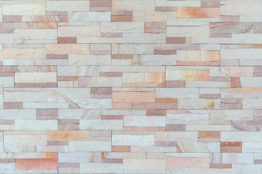 Sandstone wall background of white pink beige golden sand stone rock jigsaw tile brick block modern texture pattern for backdrop decoration