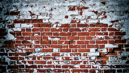Close-up of an old red brick wall with peeling plaster. Vignetting effect added