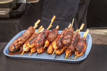 Meat kebabs on wooden skewers cooked on coals. Close-up