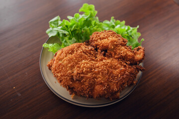 Deep fried chicken cutlet and salad vegetables