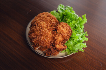 Deep fried chicken cutlet and salad vegetables