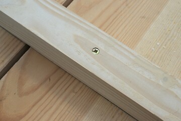 New wooden parts for garden furniture screwed together. Fragment of pine wood furniture, close-up.