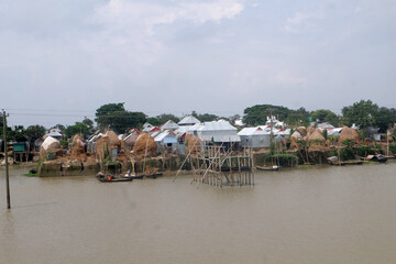 During the monsoon, the low-lying areas of Bangladesh are submerged under water. Meanwhile, the house is submerged in water around the house