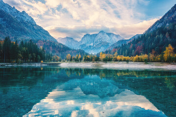 Jasna lake in Triglav national park, Kranjska Gora, Slovenia, autumn landscape. Scenic view of a clear water with reflection and stunning rocky Alps mountains, outdoor travel background - 651931381