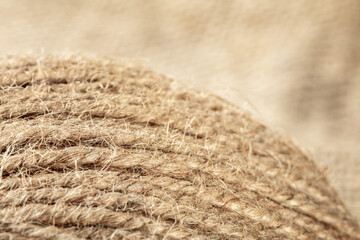 A ball of coarse textured jute threads on a burlap napkin