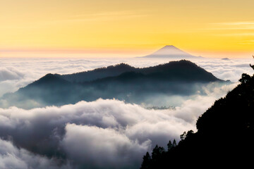 View of the sea of ​​clouds at sunset and several mountains on the Dieng plateau, Central Java,...
