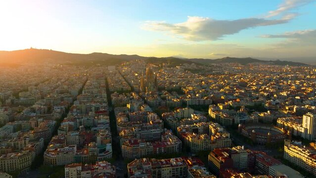 Aerial Shot of Bas&iacute;lica i Temple Expiatori de la Sagrada Fam&iacute;lia At Sunset. Avinguda de Gaud&iacute;, beautiful panorama. European cityscape. Mediterranean city. Aerial establishing shot of Barcelona. 